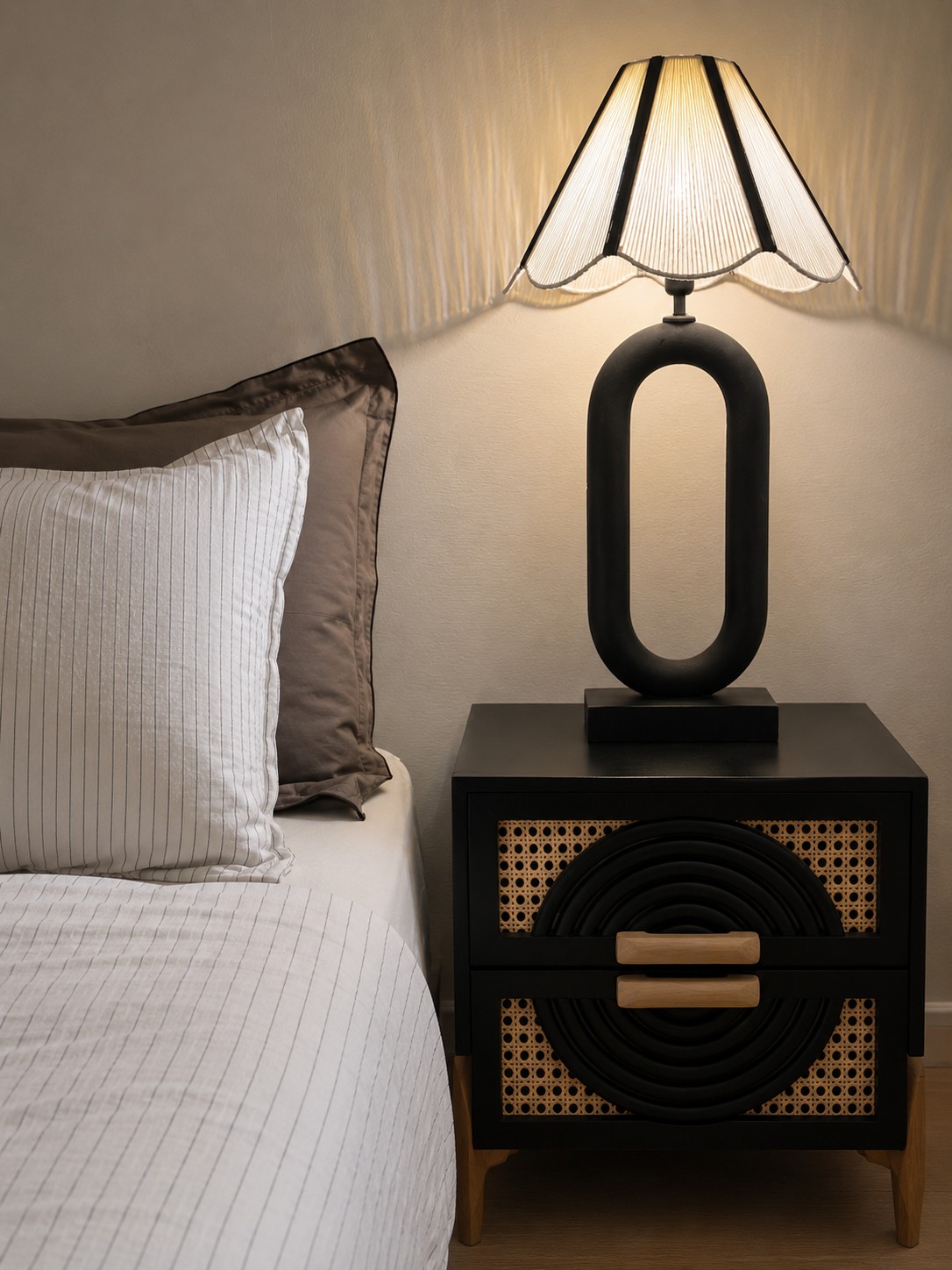 A warm bedside styling detail with layered objects and soft lighting