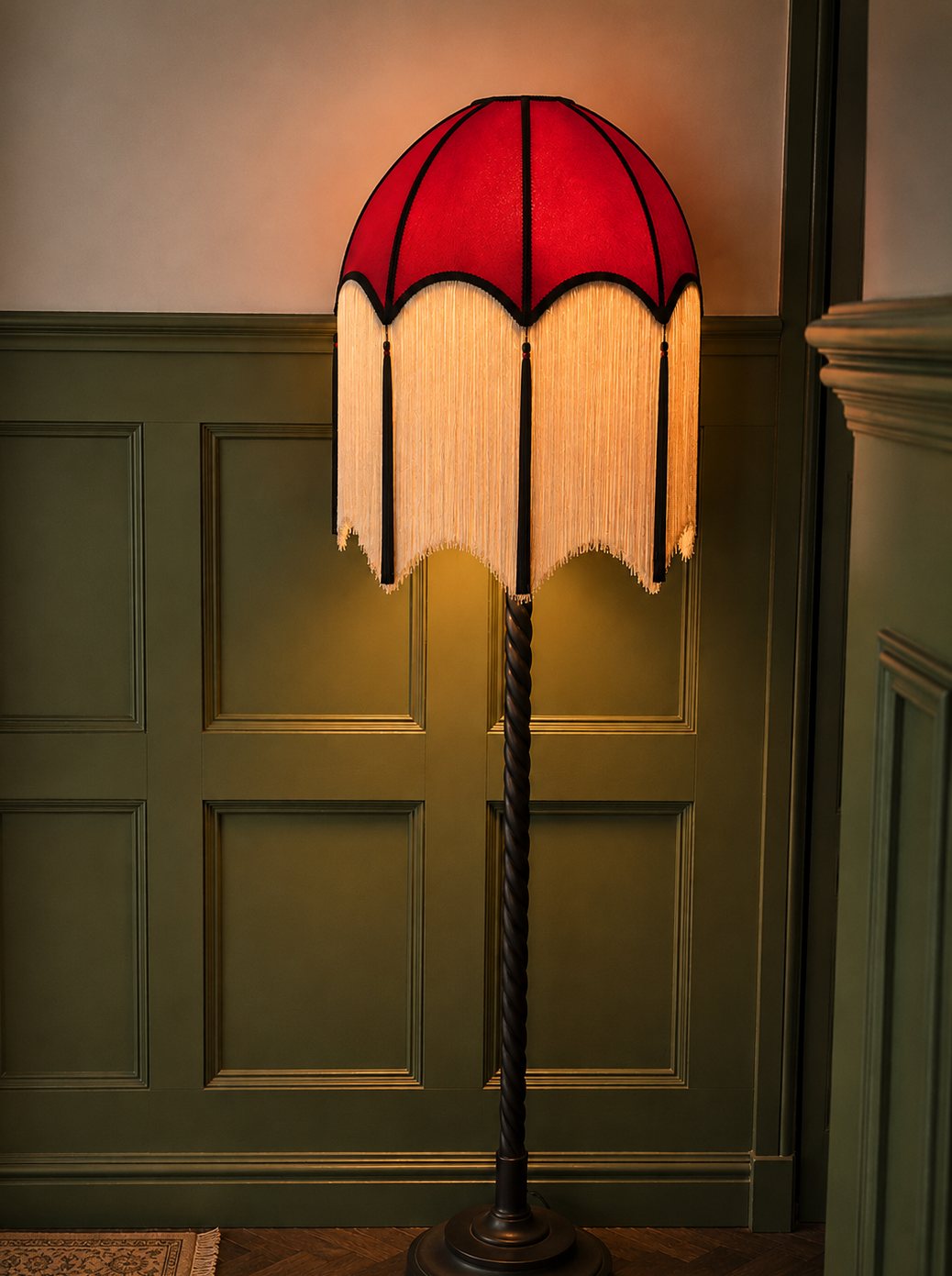 Red fringed Art Deco floor lamp glowing against sap green panelling