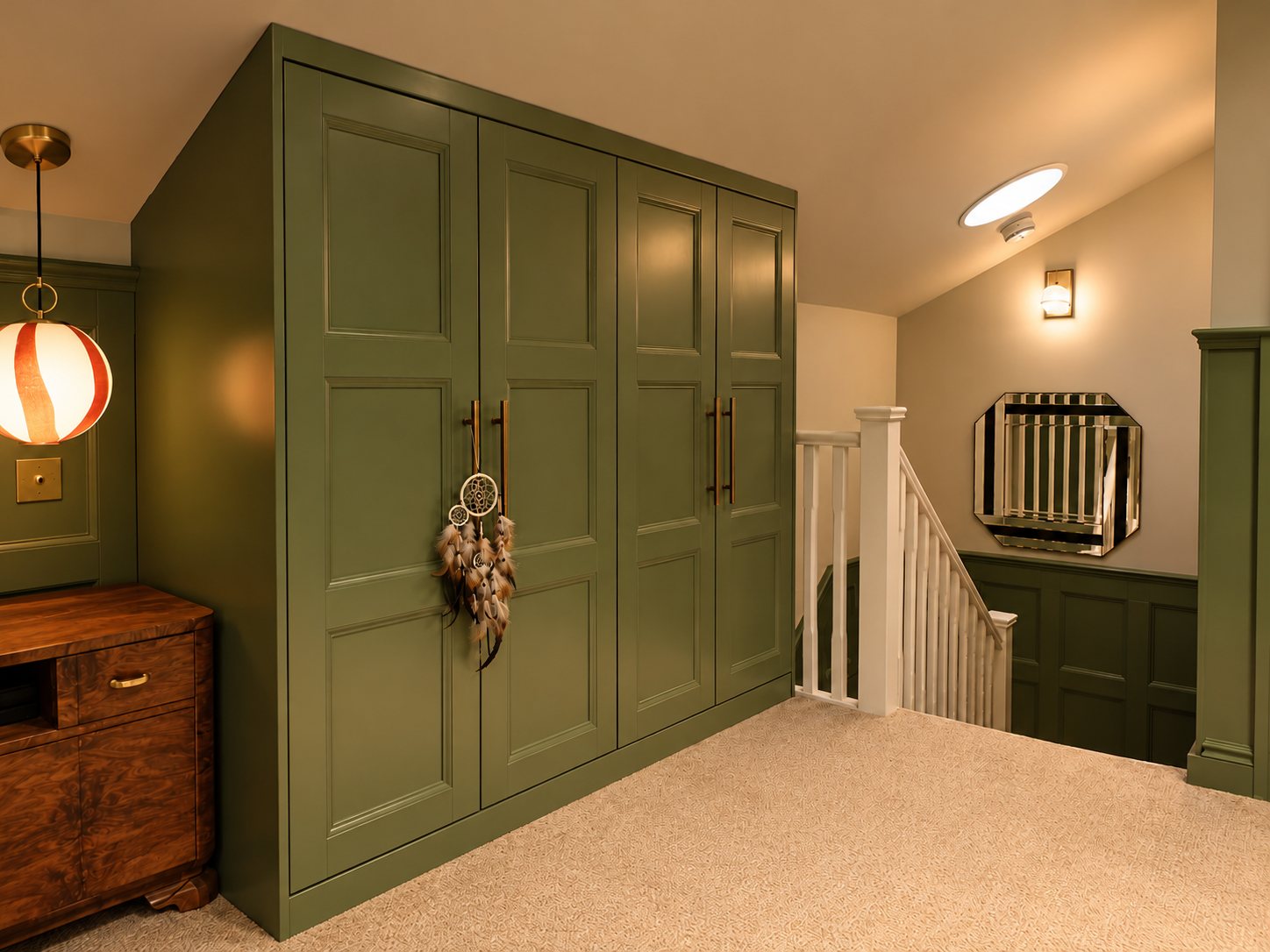 The bedroom at the top of the stairs, with green panelled wardrobes and a striped glass pendant