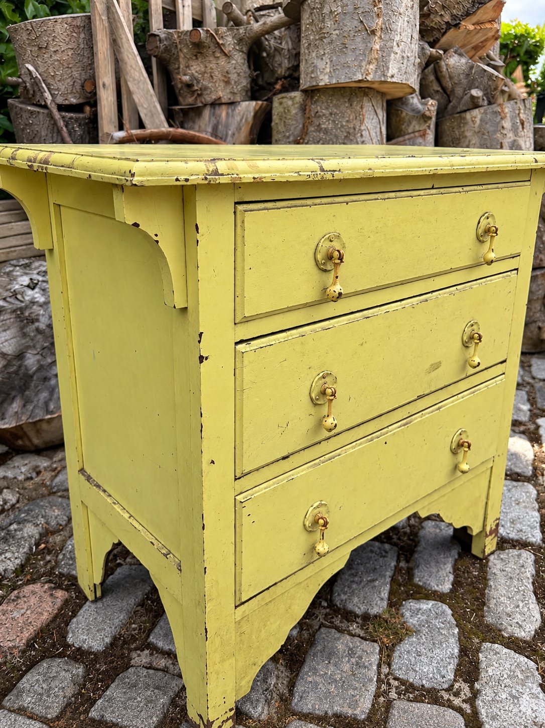 The vintage chest of drawers before restoration, painted yellow