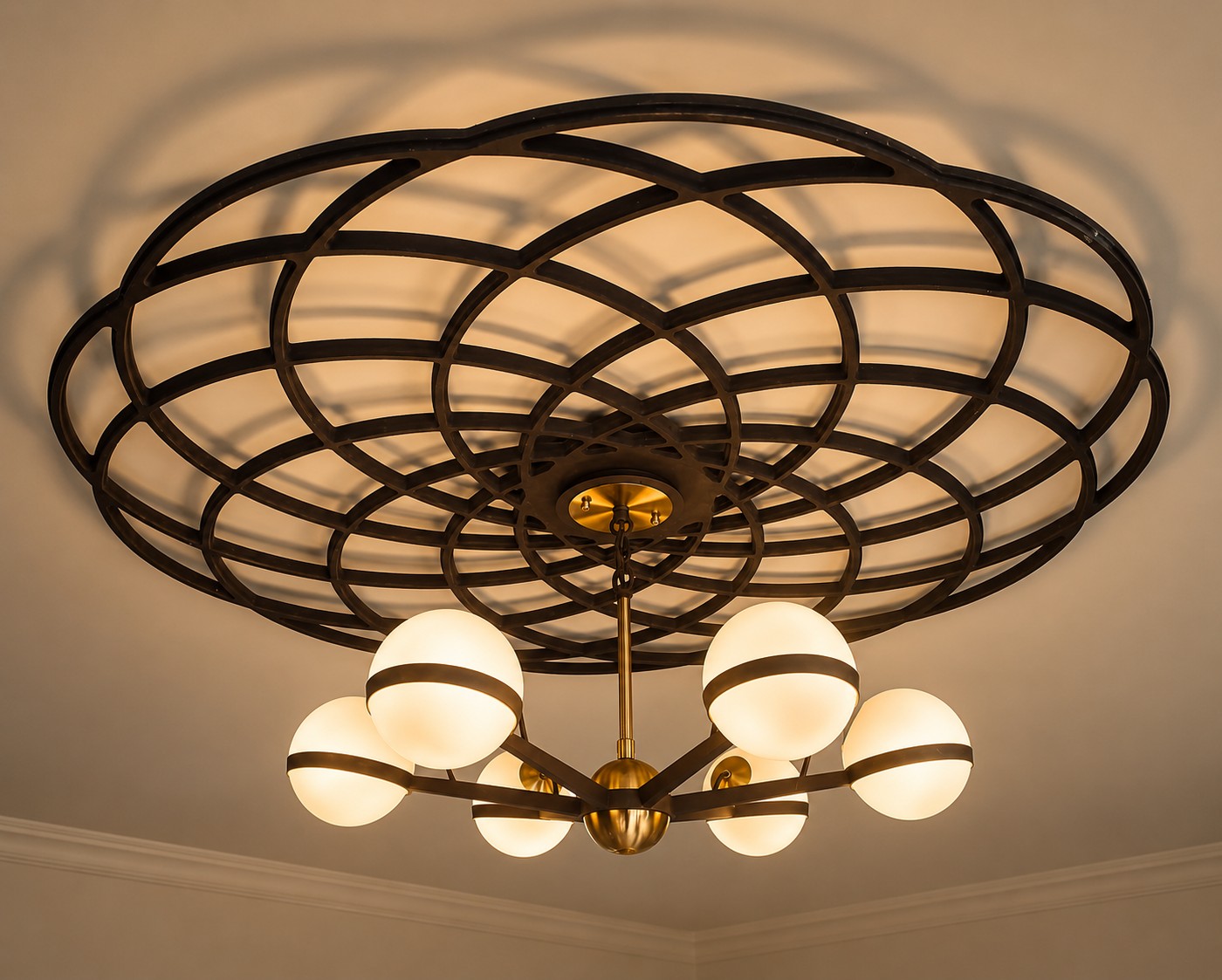 A sculptural chandelier set within its original ceiling rose